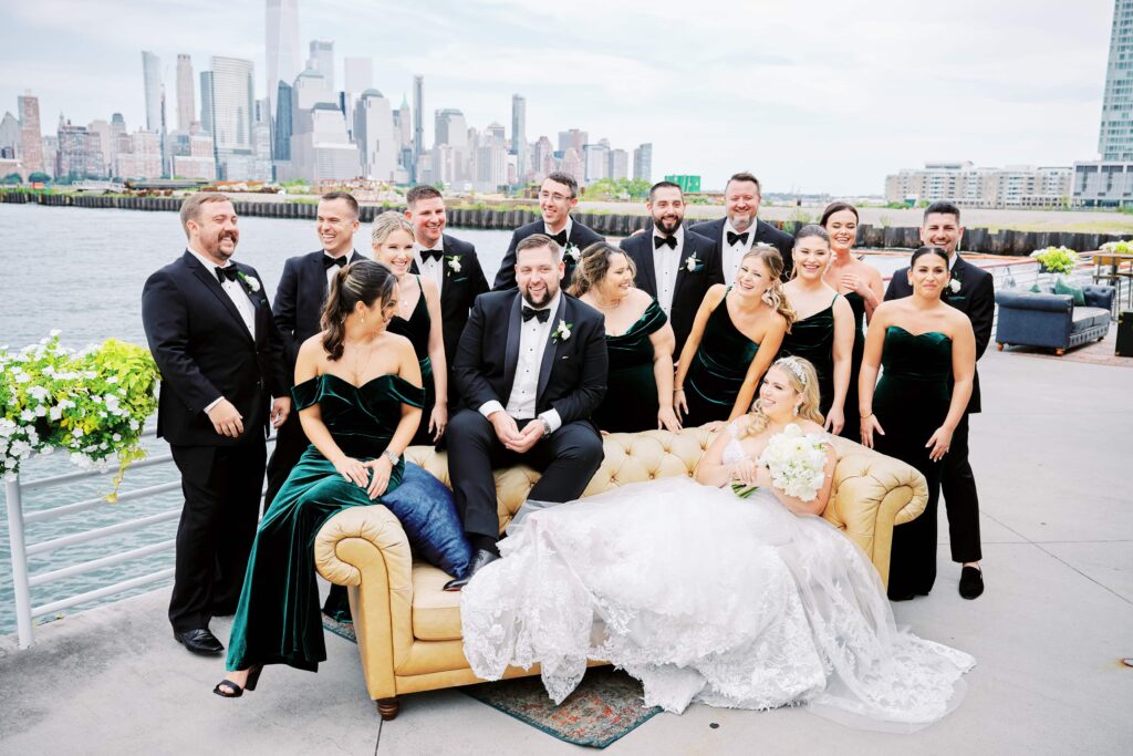 Bridal Party Gather around iconic Friends feature couch outside the Battello Wedding Venue Patio