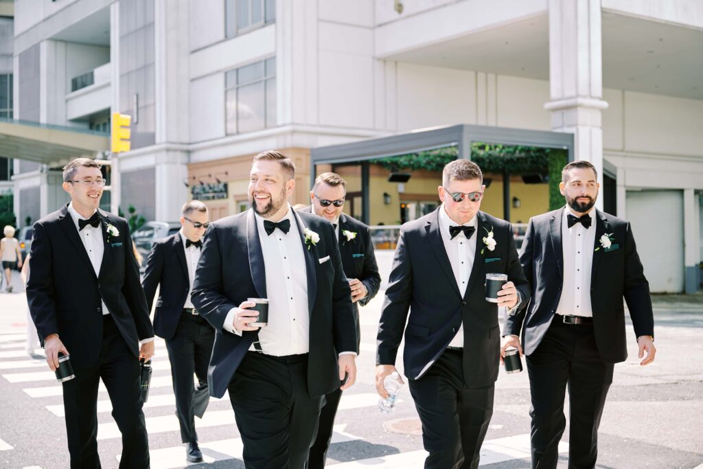 Groom & Groomsmen walking the street of Jersey City heading to Batello Wedding Venue for Wedding