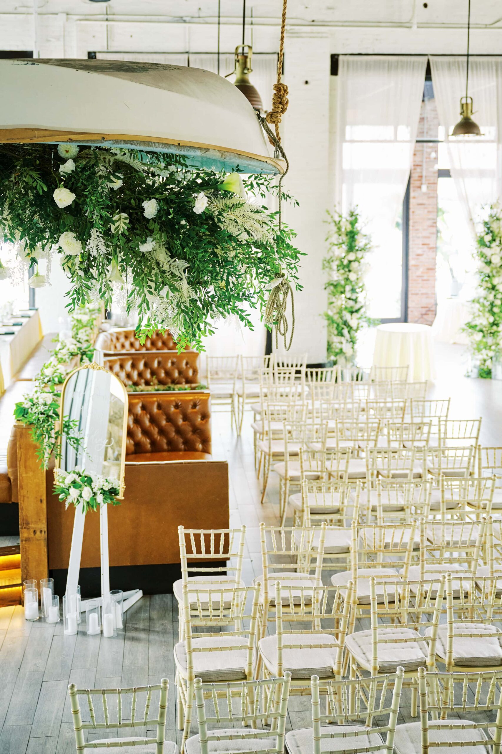Ceremony Details and Floral arrangements that hang from a ceiling fill the Battello Wedding Venue in Jersey City