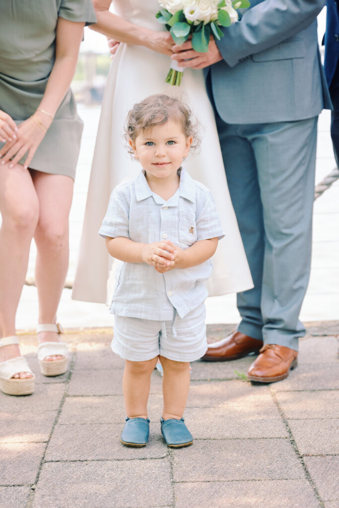 Close up photo of toddler as he stands for family formals during a Hudson Valley Wedding