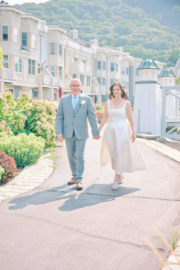 Bride and Groom Walk hand in hand in the Hudson Valley for their wedding, in a small village in the Hudson Valley New York