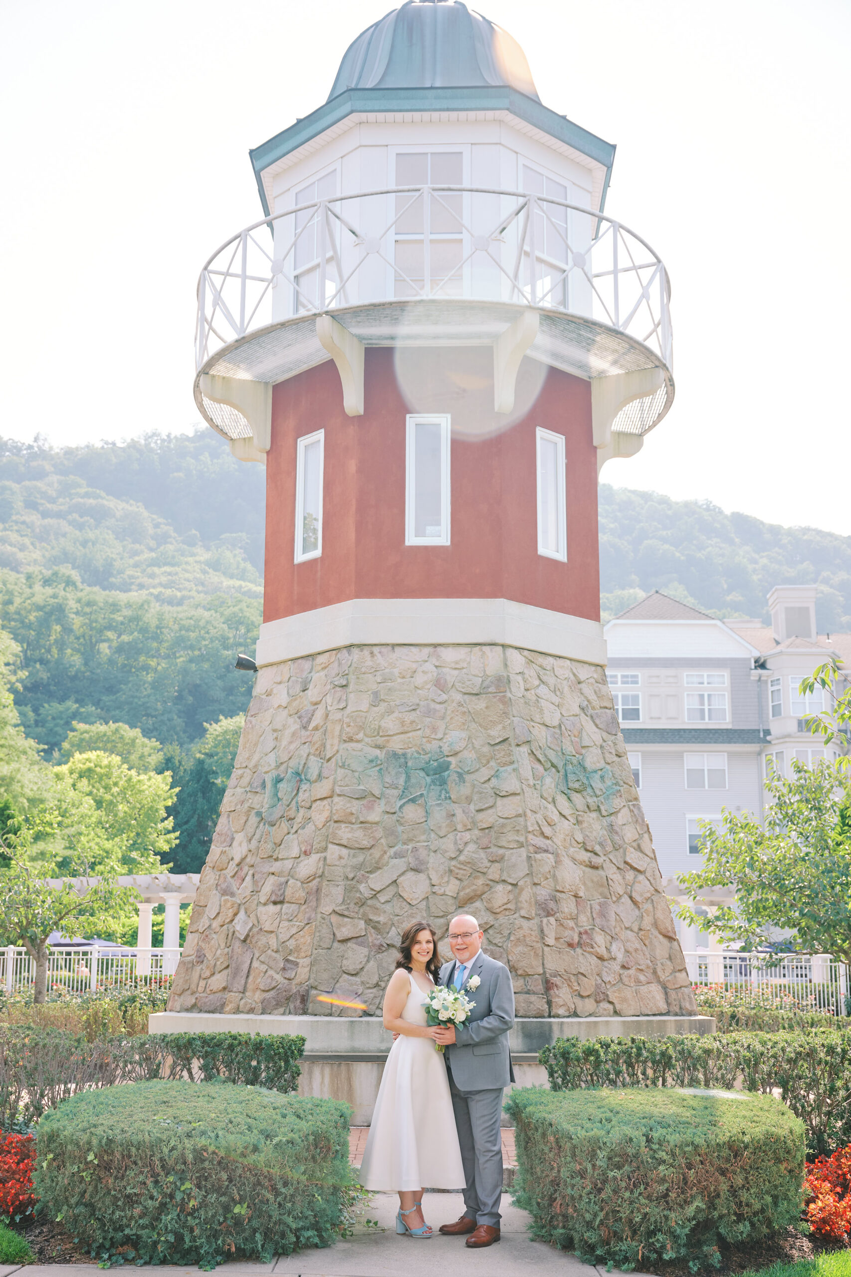 Picture of Bride and Groom in front of a town light house in Harbor Pointe.  Right before the Wedding in Hudson Valley