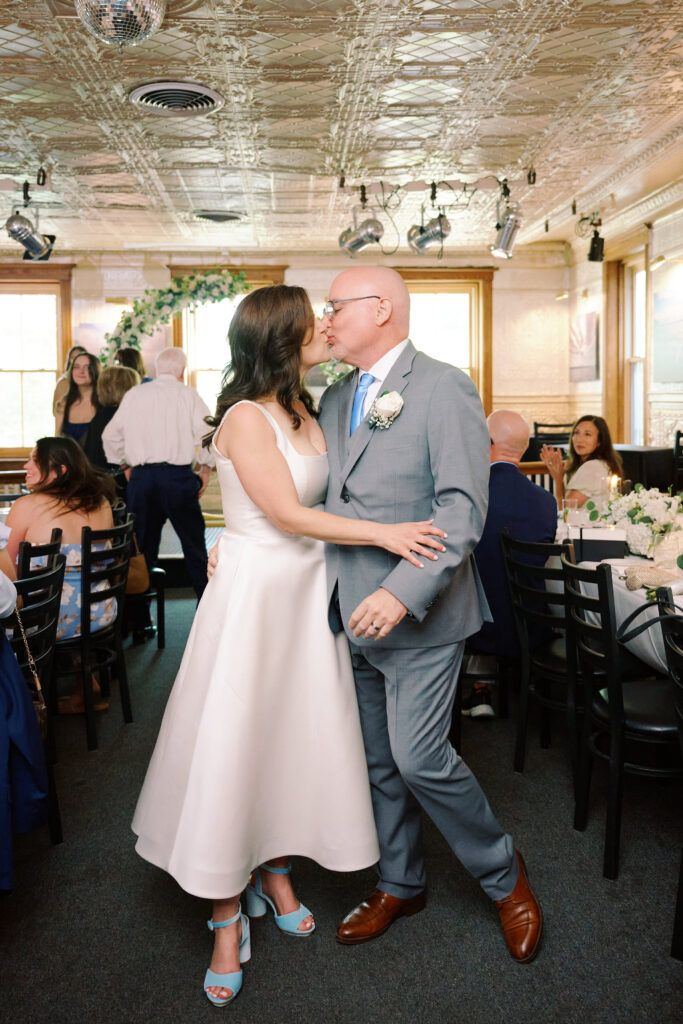 Bride and Groom Kiss in the middle of the aisle after their Wedding