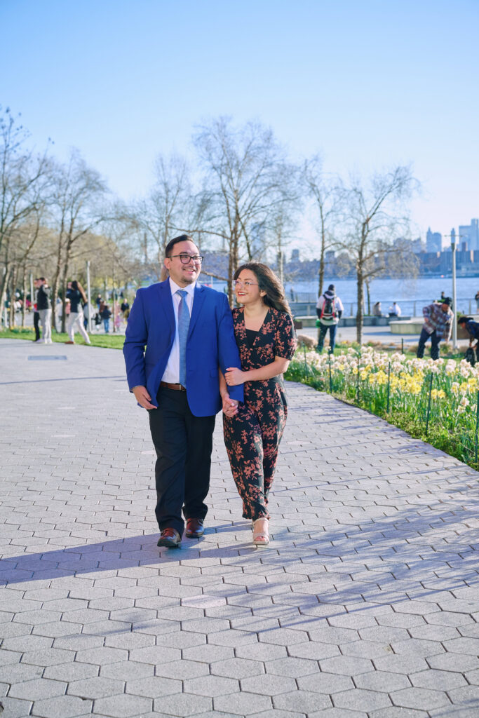 Chris & Katherine walk along the Pier at Gantry State Park after a successful proposal in NYC