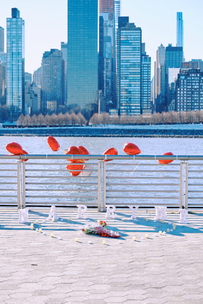 Assembled decorations for a New York City Proposal, balloons, candles & a "Marry Me" Sign at Gantry State Plaza Park