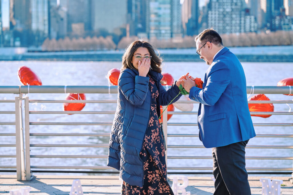 She Said Yes, Man puts on ring after his New York City Proposal overlooking the East River