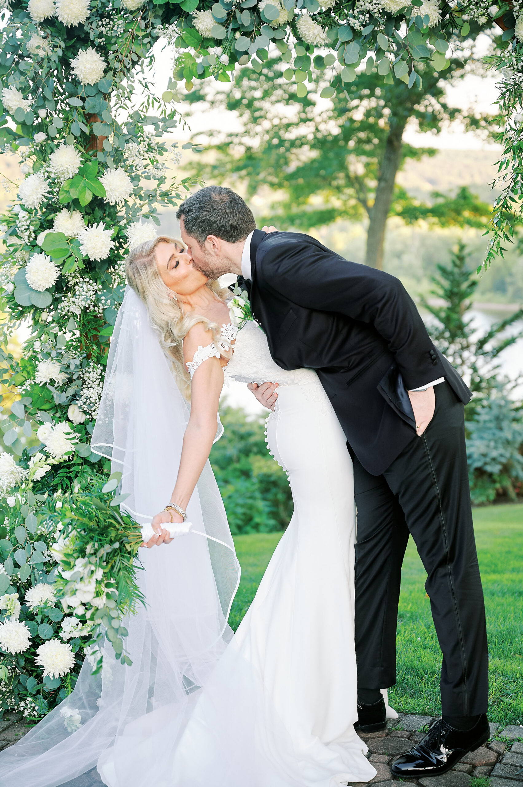 Groom Dips Bride while they kiss after their wedding Ceremony at the Saint Clements Castle and Marina. Photo taken by New York City Wedding Photographer Corey Lamar Photography