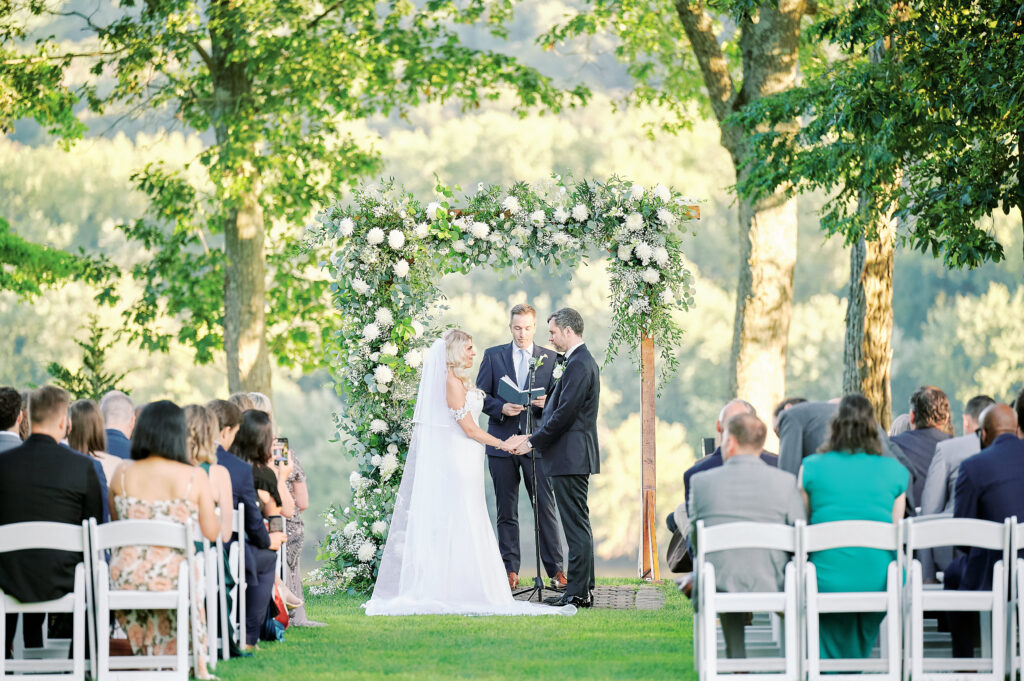 Bride and Groom stand together at their out door ceremony at the St Clements Castle