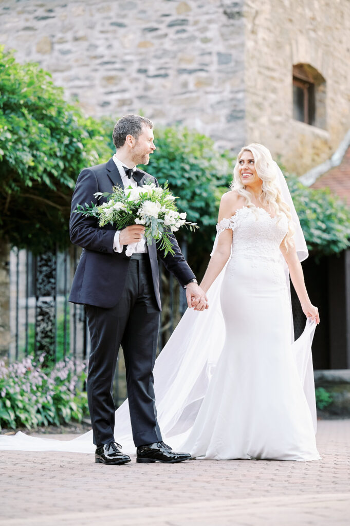 Bride and Groom walk hand in hand in the Sunken Gardens at the St Clements Castle after their wedding, photo taken by wedding photographer, Corey Lamar Photography