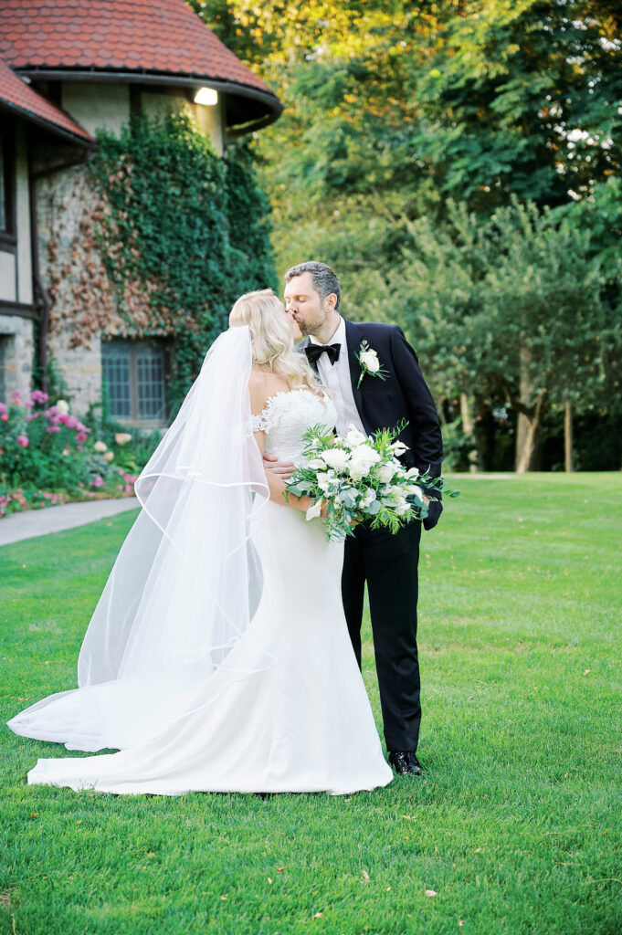 Bride and Groom kiss in the Sunken Gardens at the St Clements Castle after their wedding, photo taken by wedding photographer, Corey Lamar Photography