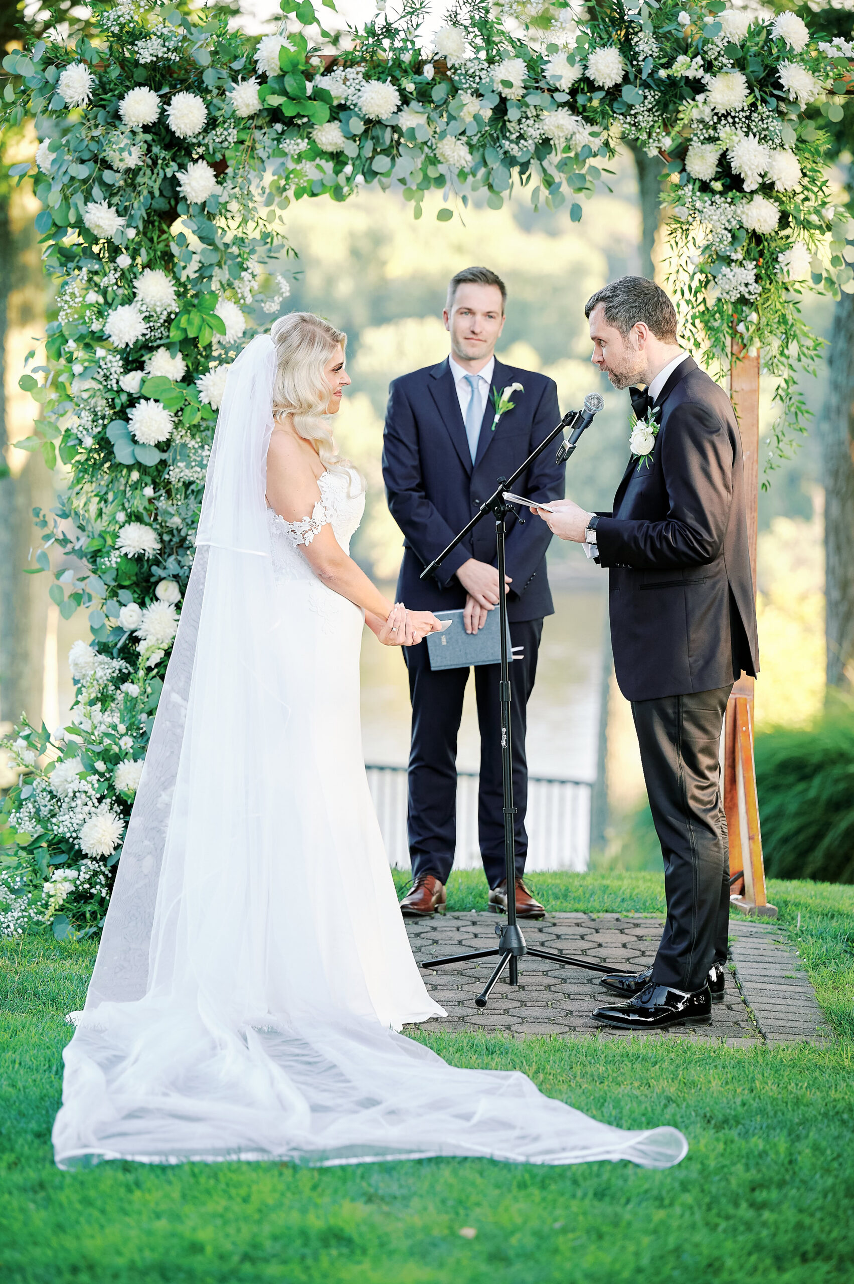 Groom Exchanges vows.  Outdoor Ceremony at the Clements Castle and Marina in Portland Connecticut.  Photo taken by Nyc Wedding Photographer Corey Lamar Photography