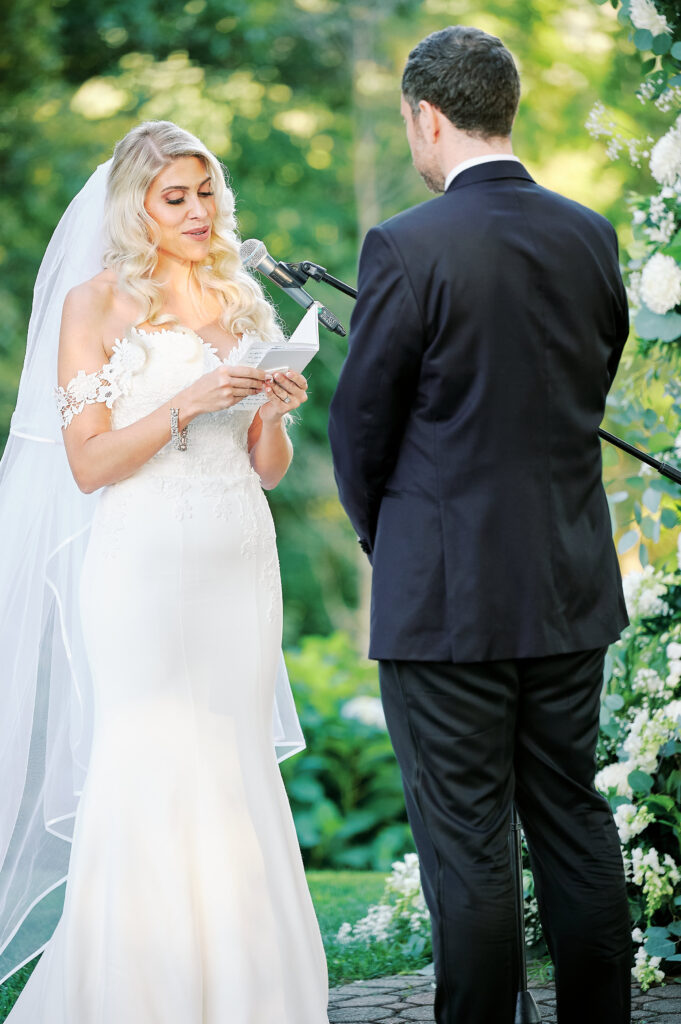 Bride Reads his vows to his bride during their outdoor ceremony at the Saint Clements Castle