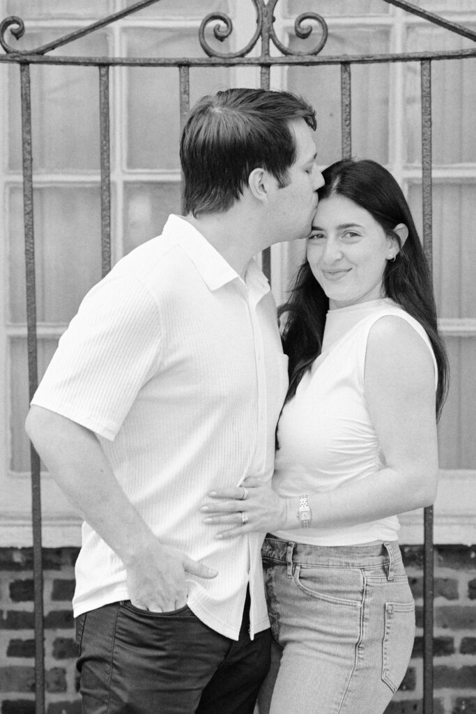 Mark kissing Vanessa’s forehead as she smiles during their West Village engagement session