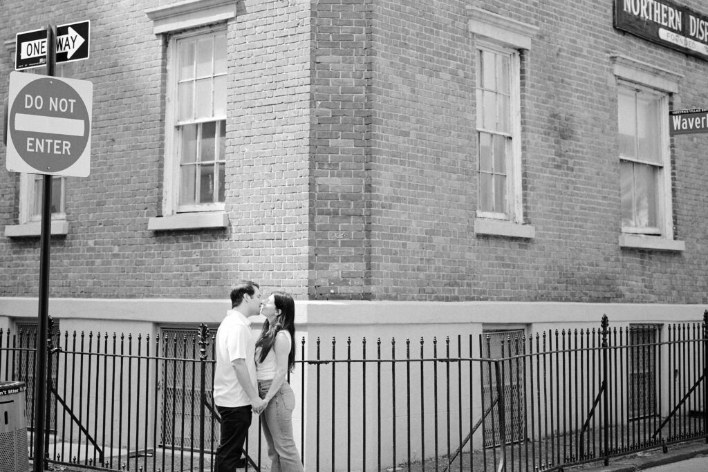 Mark and Vanessa kissing beside a ‘Do Not Enter’ sign on a West Village corner